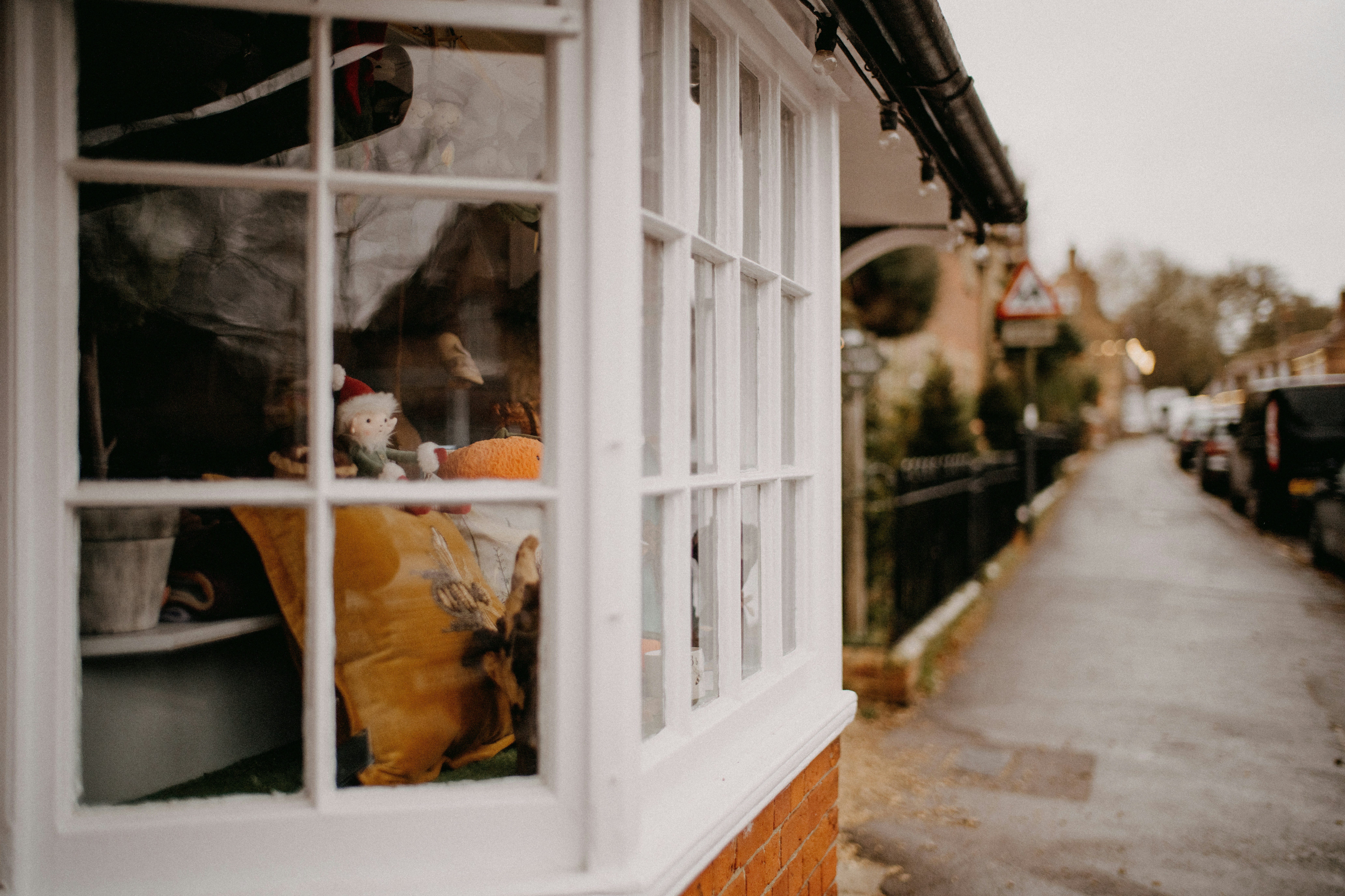 window with festive toys and stuffed animals on the inside 