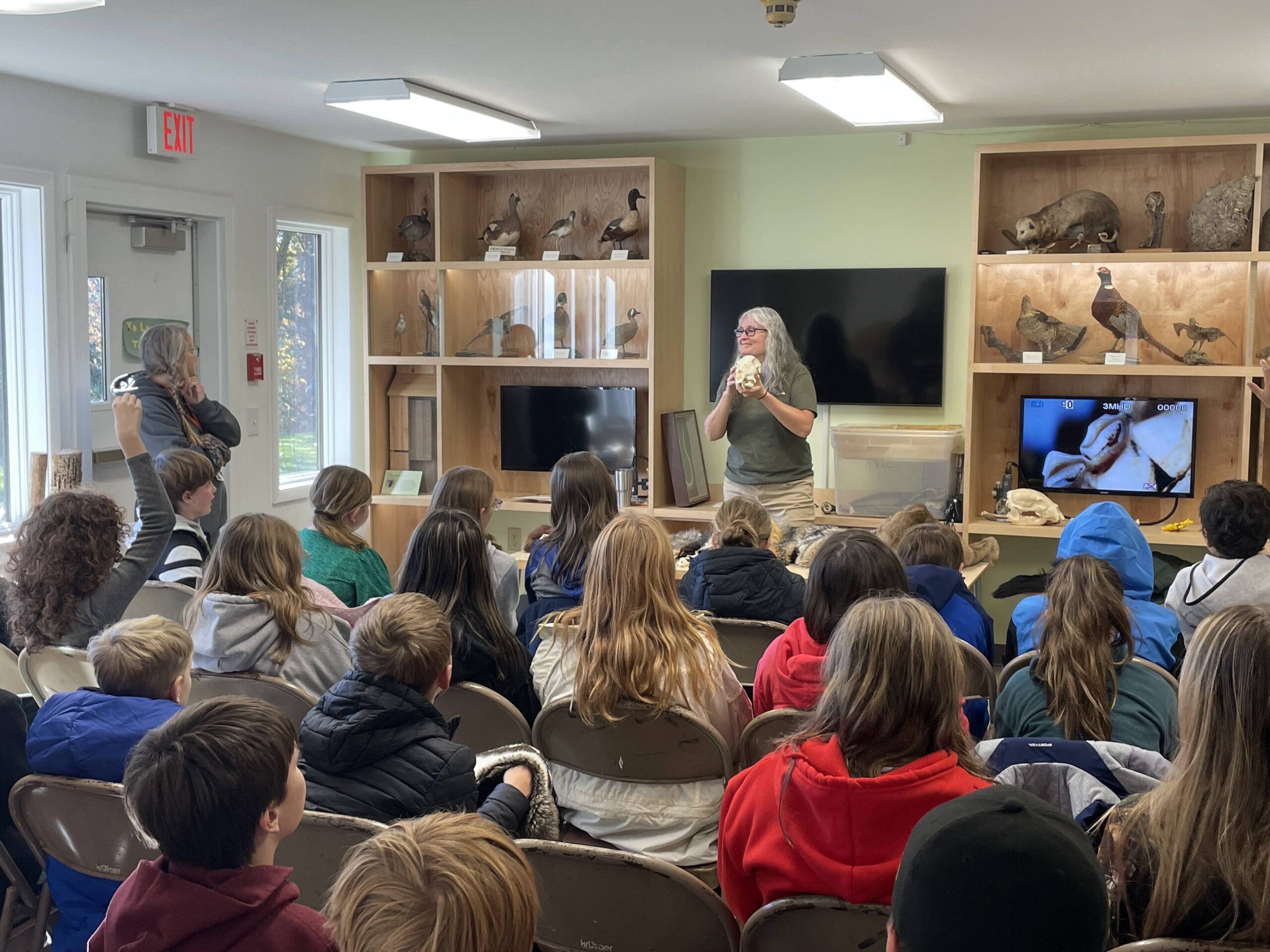 woman standing in front of room of student teaching